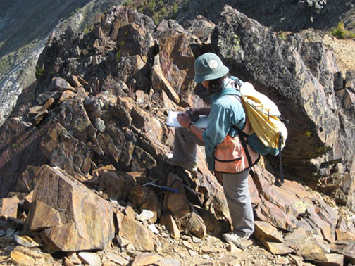 Colleen Elliott, collecting a sample in the Highland Mountains